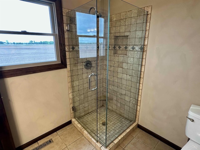 19379 Lincoln Rd, New Lothrop, MI 48460 - full bathroom featuring baseboards, tile patterned flooring, toilet, and a shower stall