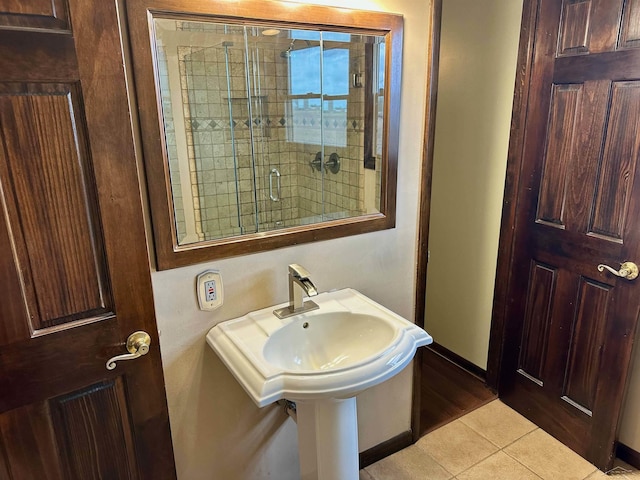 19379 Lincoln Rd, New Lothrop, MI 48460 - bathroom featuring tile patterned flooring, baseboards, and an enclosed shower