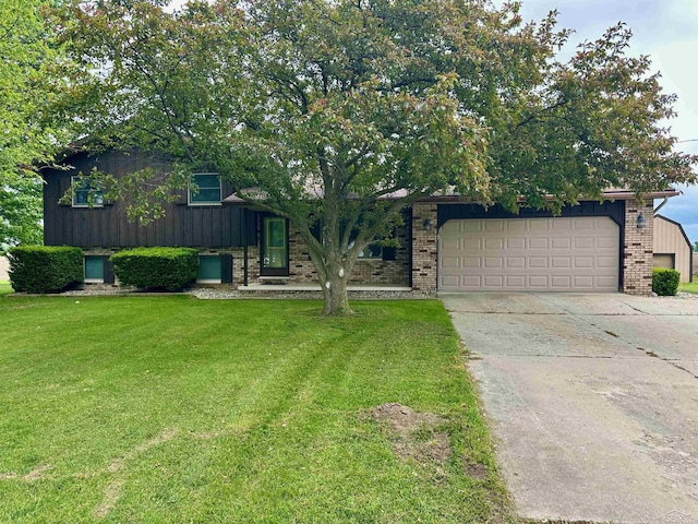 19379 Lincoln Rd, New Lothrop, MI 48460 - tri-level home with brick siding, a front lawn, an attached garage, concrete driveway, and board and batten siding
