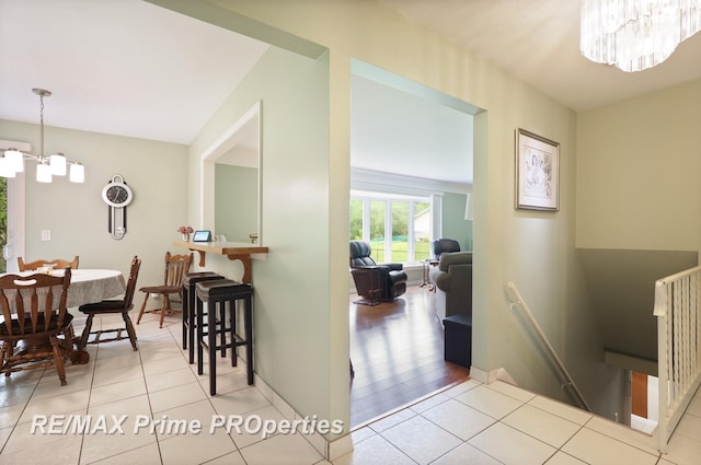 6461 Sheridan Rd, Saginaw, MI 48601 - tiled dining area featuring a chandelier and baseboards