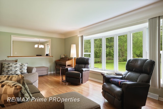 6461 Sheridan Rd, Saginaw, MI 48601 - living room featuring a chandelier, wood finished floors, and baseboards