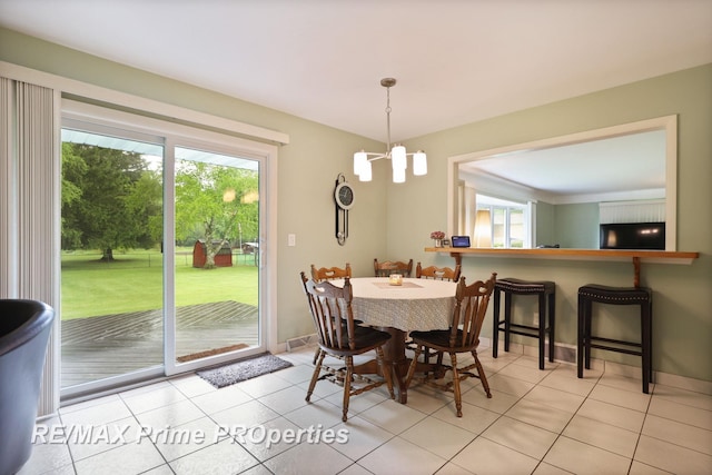 6461 Sheridan Rd, Saginaw, MI 48601 - dining space featuring a chandelier, light tile patterned floors, and baseboards