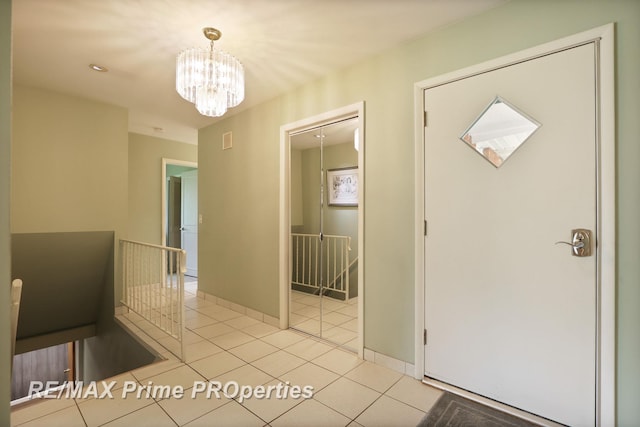 6461 Sheridan Rd, Saginaw, MI 48601 - foyer with a chandelier, light tile patterned floors, and baseboards