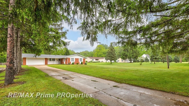 6461 Sheridan Rd, Saginaw, MI 48601 - ranch-style house with driveway, an attached garage, a front yard, and brick siding