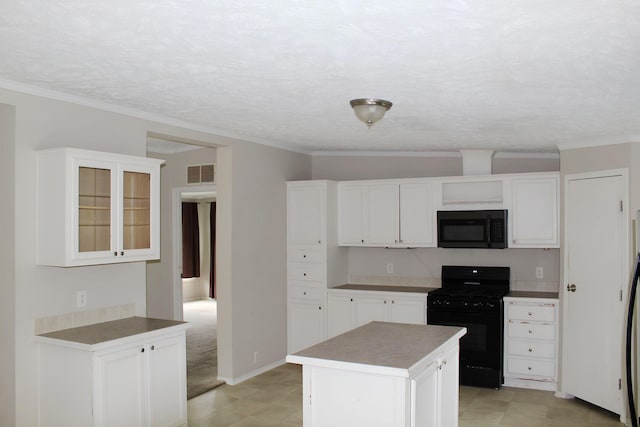 11200 Willard Rd, Burt, MI 48417 - kitchen with black appliances, crown molding, a center island, and white cabinets