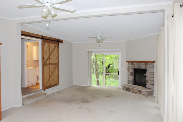 11200 Willard Rd, Burt, MI 48417 - unfurnished living room featuring carpet flooring, a barn door, a ceiling fan, a fireplace, and ornamental molding