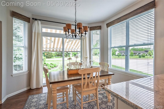 26727 Wilton Ct, New Hudson, MI 48165 - dining space with baseboards, healthy amount of natural light, a chandelier, and dark wood-type flooring