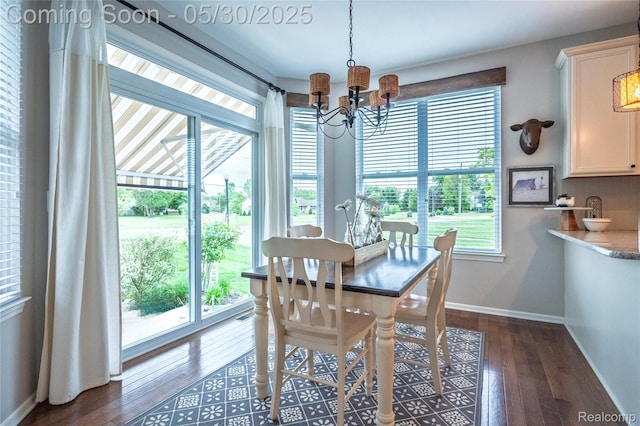 26727 Wilton Ct, New Hudson, MI 48165 - dining room featuring a chandelier, plenty of natural light, baseboards, and dark wood-style flooring