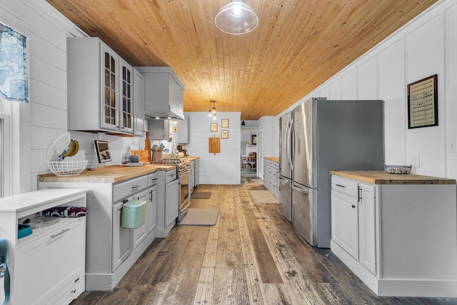 9410 US Highway 12, Brooklyn, MI 49230 - kitchen with butcher block countertops, wooden ceiling, appliances with stainless steel finishes, dark wood finished floors, and glass insert cabinets