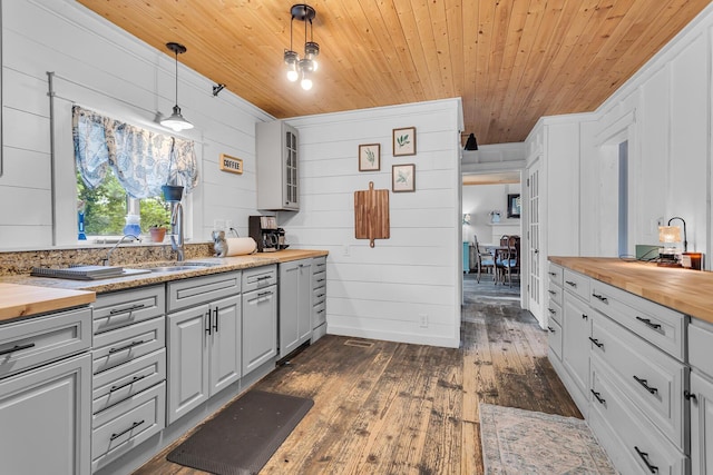 9410 US Highway 12, Brooklyn, MI 49230 - kitchen featuring wooden counters, wood ceiling, a sink, dark wood-style flooring, and wood walls