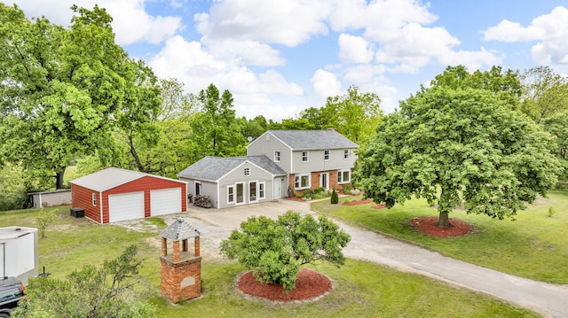 9410 US Highway 12, Brooklyn, MI 49230 - view of front of property with driveway, a front yard, an outbuilding, and a garage