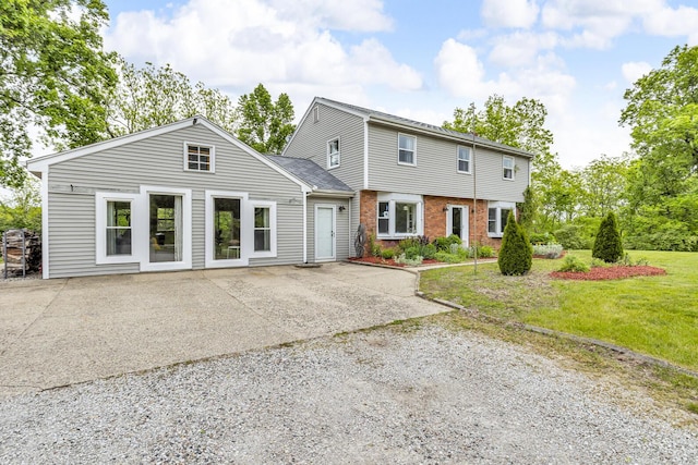 9410 US Highway 12, Brooklyn, MI 49230 - view of front of home with brick siding, a front lawn, and a patio area