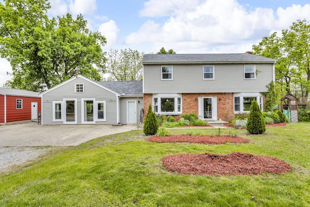 9410 US Highway 12, Brooklyn, MI 49230 - colonial house with a front lawn and brick siding