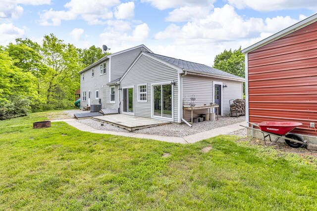9410 US Highway 12, Brooklyn, MI 49230 - rear view of property featuring a lawn, cooling unit, and a deck