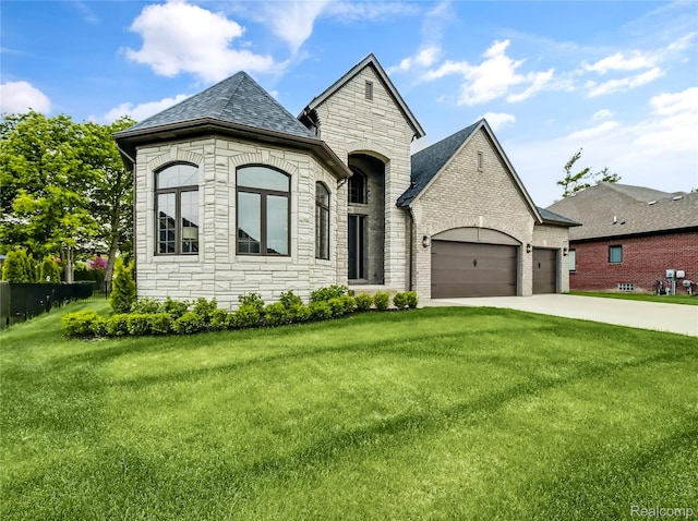 50011 Anita Way N, Macomb, MI 48044 - french country inspired facade with stone siding, a garage, a front lawn, and driveway