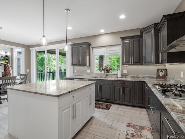 50011 Anita Way N, Macomb, MI 48044 - kitchen with stainless steel gas stovetop, a sink, a center island, light stone counters, and hanging light fixtures