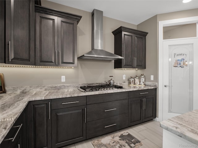 50011 Anita Way N, Macomb, MI 48044 - kitchen with wall chimney range hood, stainless steel gas cooktop, dark brown cabinets, and light stone counters