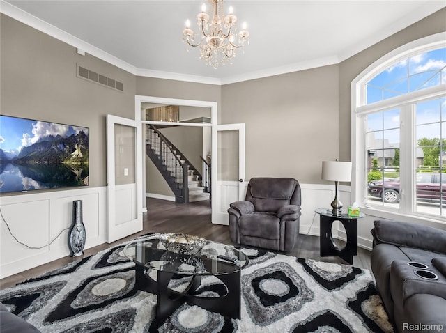 50011 Anita Way N, Macomb, MI 48044 - living area featuring a chandelier, stairs, ornamental molding, dark wood-style flooring, and a wainscoted wall