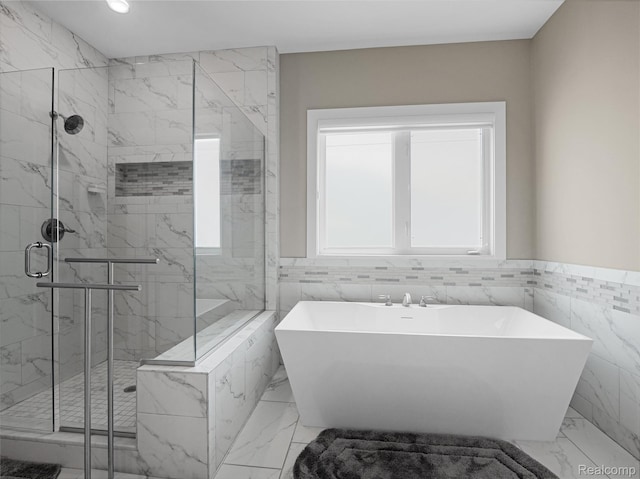 50011 Anita Way N, Macomb, MI 48044 - full bathroom featuring tile walls, a freestanding bath, a marble finish shower, marble finish flooring, and wainscoting