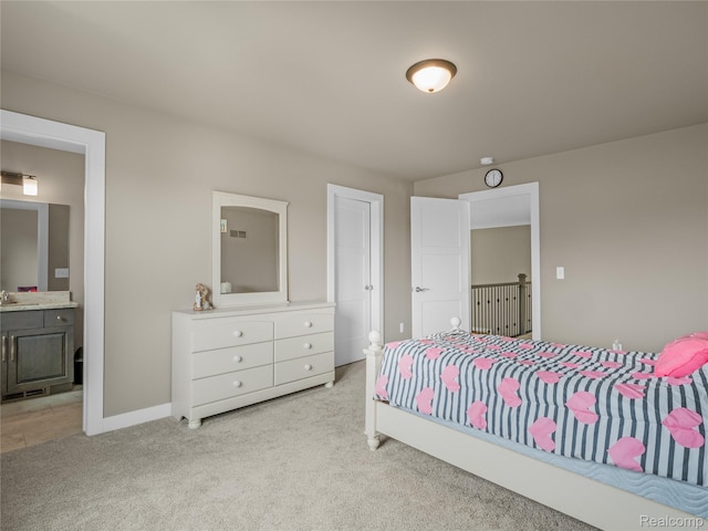 50011 Anita Way N, Macomb, MI 48044 - bedroom with light colored carpet, ensuite bathroom, a sink, and baseboards