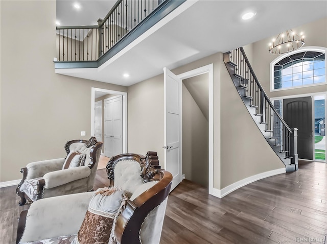 50011 Anita Way N, Macomb, MI 48044 - foyer featuring a chandelier, stairway, wood finished floors, a towering ceiling, and baseboards