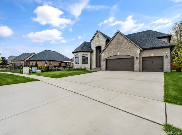50011 Anita Way N, Macomb, MI 48044 - french country home with brick siding, a garage, driveway, a shingled roof, and stone siding