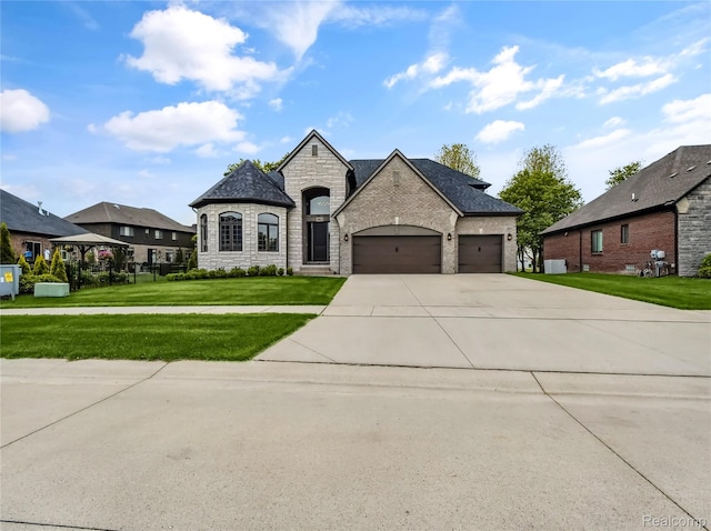 50011 Anita Way N, Macomb, MI 48044 - french country inspired facade with stone siding, an attached garage, driveway, a front lawn, and central AC unit