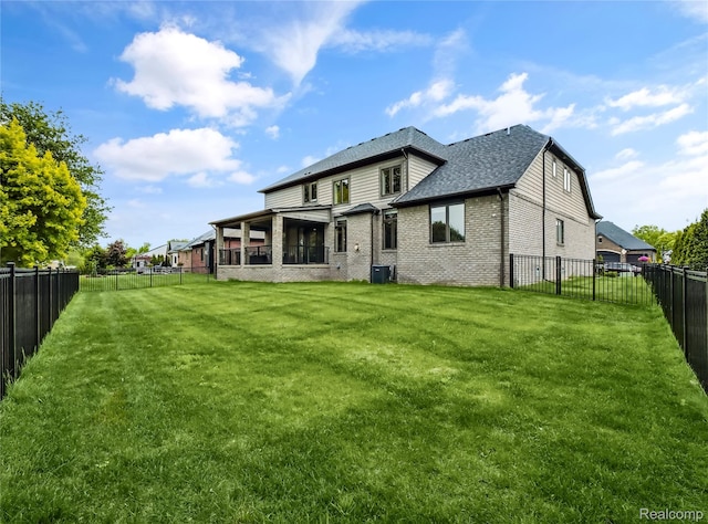 50011 Anita Way N, Macomb, MI 48044 - rear view of property with brick siding, central AC, and a shingled roof