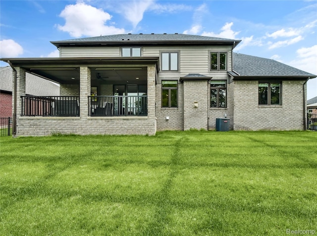 50011 Anita Way N, Macomb, MI 48044 - rear view of house featuring a yard, central AC, brick siding, roof with shingles, and ceiling fan