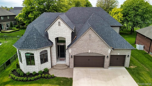 50011 Anita Way N, Macomb, MI 48044 - french provincial home featuring stone siding, an attached garage, concrete driveway, and roof with shingles