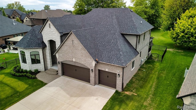 50011 Anita Way N, Macomb, MI 48044 - view of front of property featuring a garage, stone siding, roof with shingles, concrete driveway, and brick siding