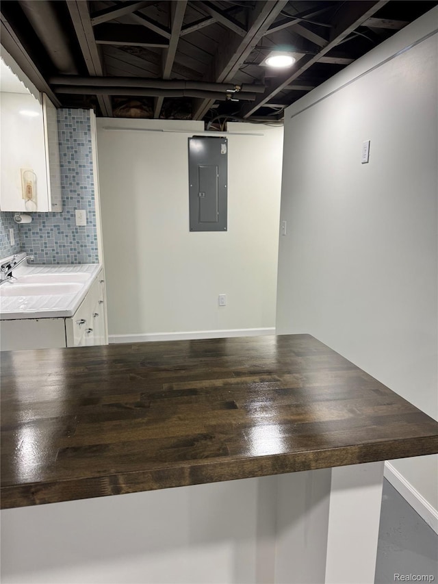 8511 Allen Rd, Allen Park, MI 48101 - finished basement with electric panel, wood finished floors, a sink, and baseboards