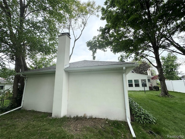 8511 Allen Rd, Allen Park, MI 48101 - view of property exterior with stucco siding, a chimney, and a shingled roof
