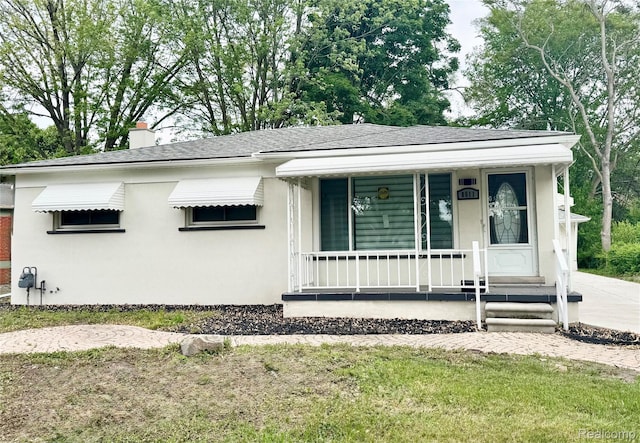 8511 Allen Rd, Allen Park, MI 48101 - bungalow-style house with a porch, stucco siding, a shingled roof, and a chimney