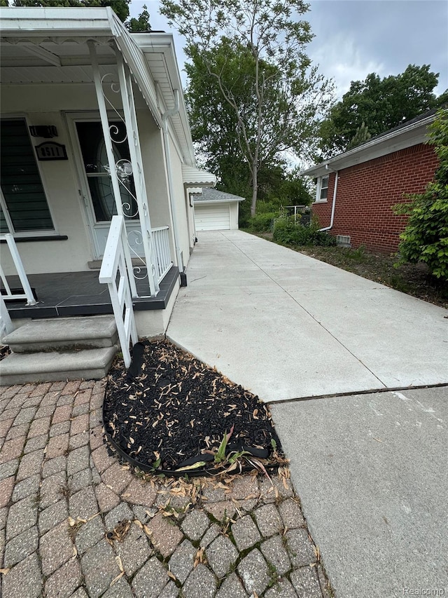 8511 Allen Rd, Allen Park, MI 48101 - view of home's exterior featuring a porch, a detached garage, and stucco siding