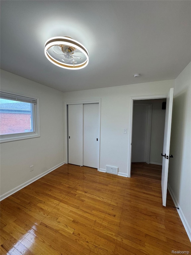 8511 Allen Rd, Allen Park, MI 48101 - unfurnished bedroom with light wood-style floors, baseboards, and a closet