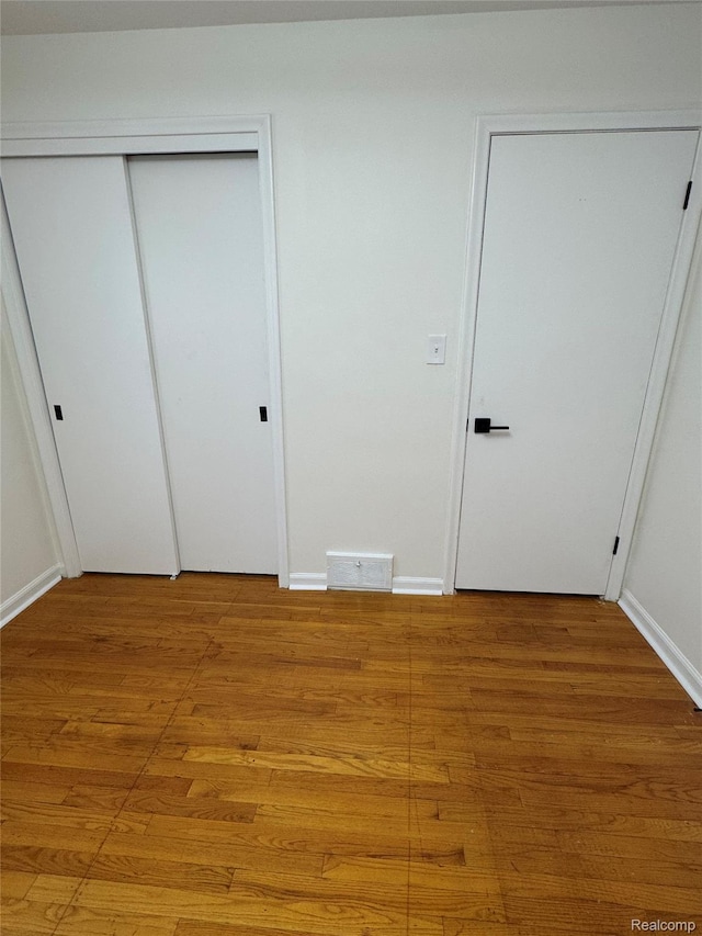 8511 Allen Rd, Allen Park, MI 48101 - unfurnished bedroom with light wood finished floors and baseboards