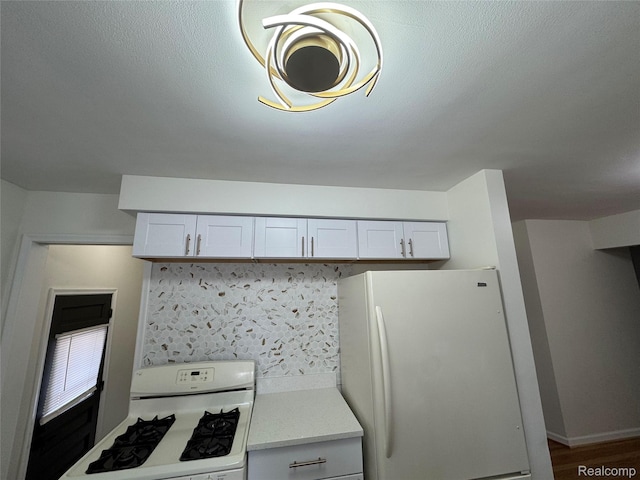 8511 Allen Rd, Allen Park, MI 48101 - kitchen with white appliances, light countertops, decorative backsplash, and white cabinets