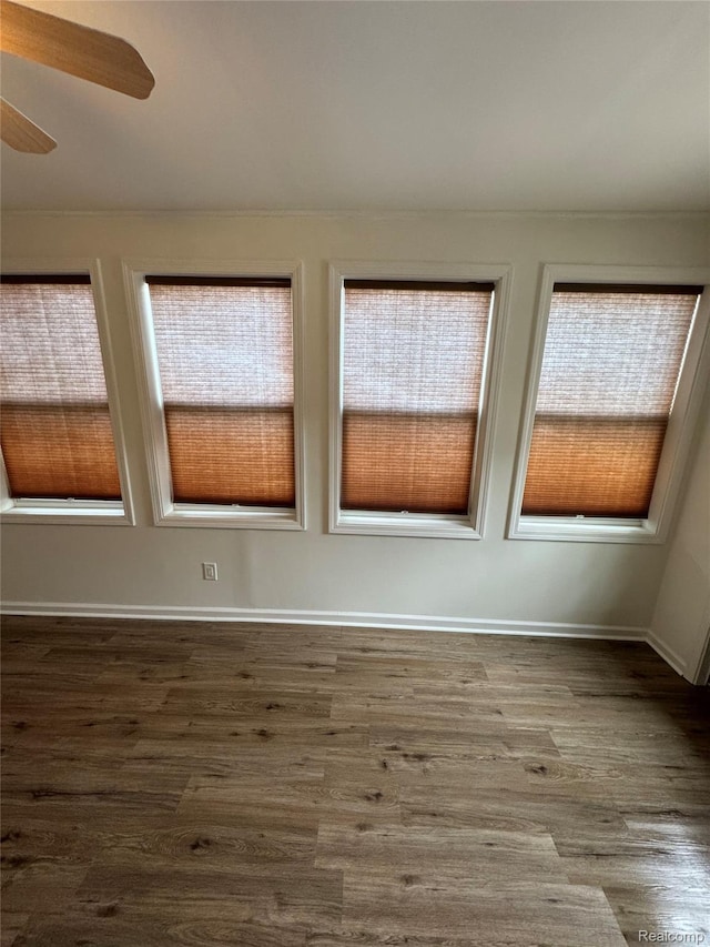 8511 Allen Rd, Allen Park, MI 48101 - empty room featuring dark wood-style flooring, a ceiling fan, and baseboards