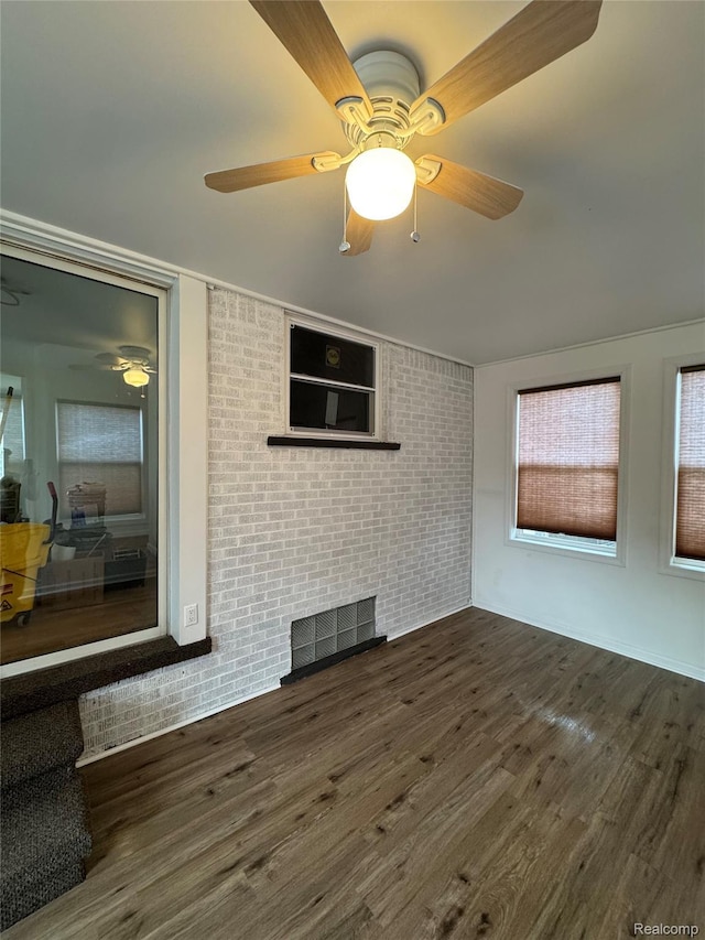 8511 Allen Rd, Allen Park, MI 48101 - unfurnished living room with ceiling fan, brick wall, and dark wood finished floors
