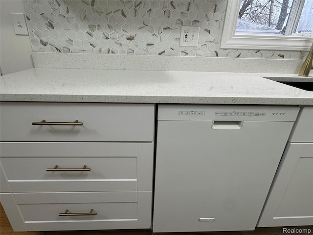 8511 Allen Rd, Allen Park, MI 48101 - kitchen view of white dishwasher, decorative backsplash, light stone countertops, and white cabinets