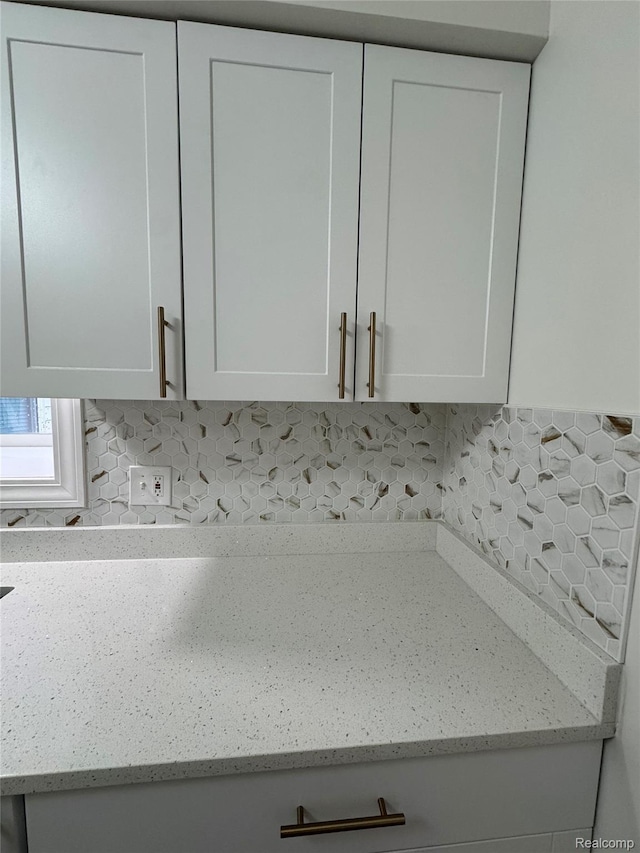 8511 Allen Rd, Allen Park, MI 48101 - kitchen view of white cabinets, decorative backsplash, and light stone counters