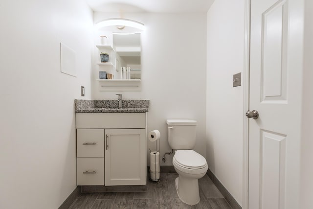 1512 Brooklyn Ave, Ann Arbor, MI 48104 - half bathroom with toilet, vanity, baseboards, and wood finished floors