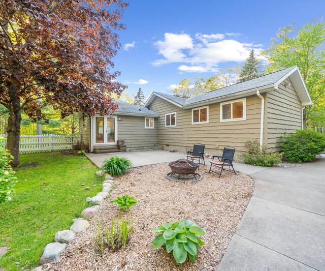 4841 Pear Way, Farwell, MI 48622 - back of property featuring a patio area, an outdoor fire pit, and roof with shingles
