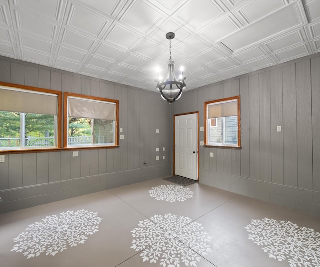 4841 Pear Way, Farwell, MI 48622 - spare room with an ornate ceiling, a chandelier, plenty of natural light, and wood walls