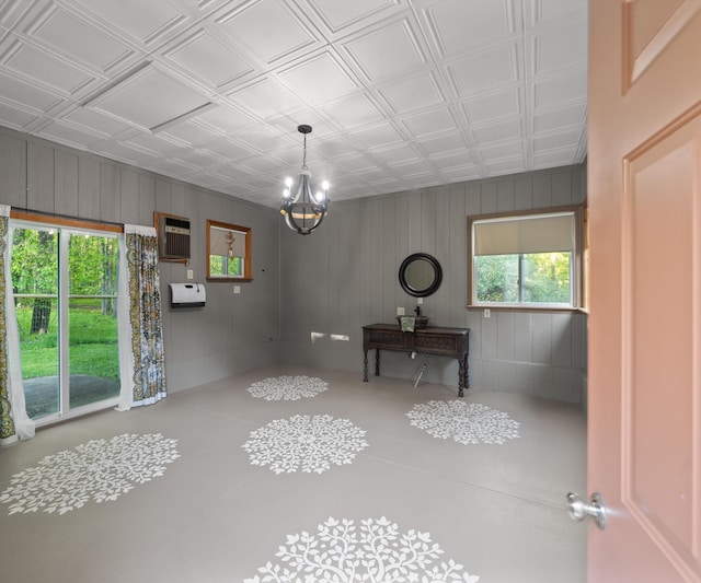 4841 Pear Way, Farwell, MI 48622 - unfurnished dining area featuring a chandelier, an ornate ceiling, and wooden walls