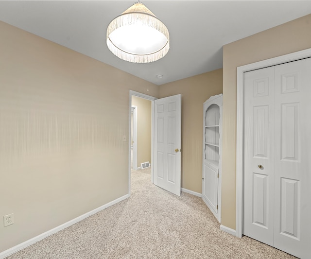 4841 Pear Way, Farwell, MI 48622 - unfurnished bedroom with carpet flooring, baseboards, and a closet