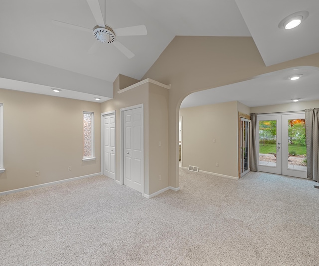 4841 Pear Way, Farwell, MI 48622 - unfurnished room featuring arched walkways, high vaulted ceiling, ceiling fan, light carpet, and baseboards