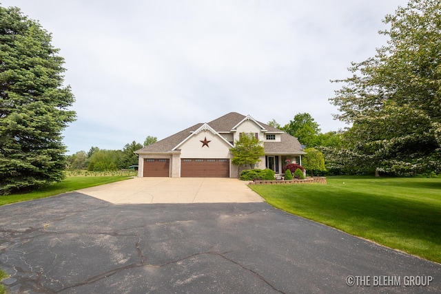 1705 Fritz St, Marne, MI 49435 - view of front of home with an attached garage, a front lawn, and driveway