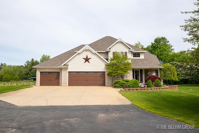 1705 Fritz St, Marne, MI 49435 - view of front of home featuring a front lawn, driveway, a garage, brick siding, and a shingled roof